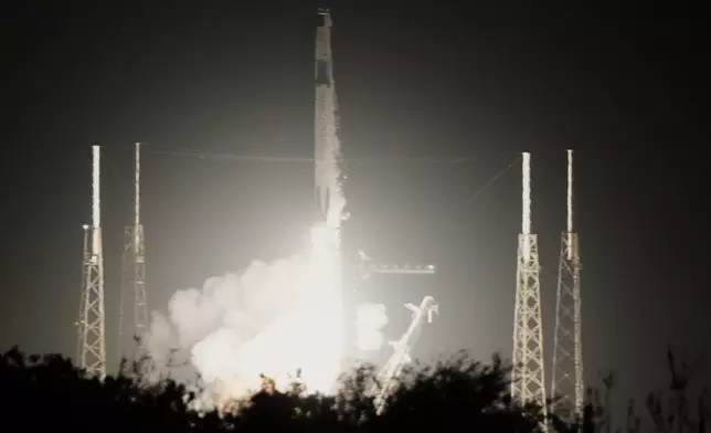 A SpaceX Falcon 9 rocket with a crew of four aboard the Dragon space craft lifts off from pad 40 at the Cape Canaveral Space Force Station in Cape Canaveral, Fla., Friday, Feb. 13, 2026. (AP Photo/John Raoux)