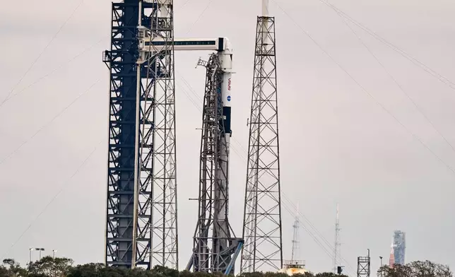 A SpaceX Falcon 9 rocket with a Dragon spacecraft stands ready for launch on pad 40 at the Cape Canaveral Space Force Station in Cape Canaveral, Fla., Thursday, Feb. 12, 2026 . (AP Photo/John Raoux)