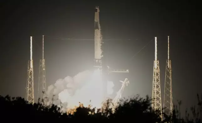 A SpaceX Falcon 9 rocket with a crew of four aboard the Dragon space craft lifts off from pad 40 at the Cape Canaveral Space Force Station in Cape Canaveral, Fla., Friday, Feb. 13, 2026 . (AP Photo/John Raoux)