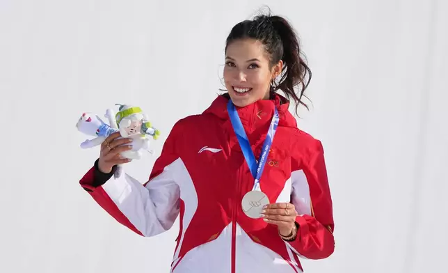 Silver medalist China's Eileen Gu celebrates after the women's freestyle skiing slopestyle finals at the 2026 Winter Olympics, in Livigno, Italy, Monday, Feb. 9, 2026. (AP Photo/Gregory Bull)