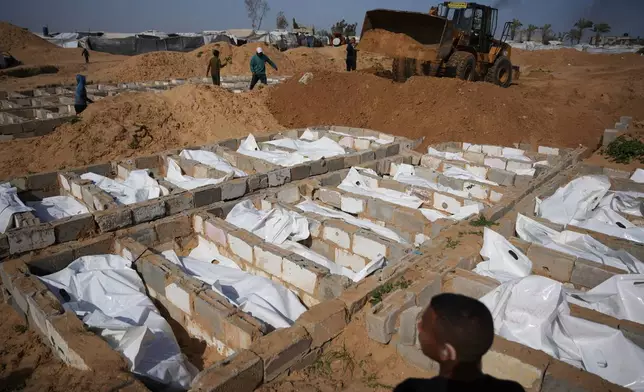 Bodies of unidentified Palestinians returned from Israel as part of the ceasefire deal are buried in Deir al-Balah, Gaza Strip, Friday, Feb. 13, 2026. (AP Photo/Abdel Kareem Hana)