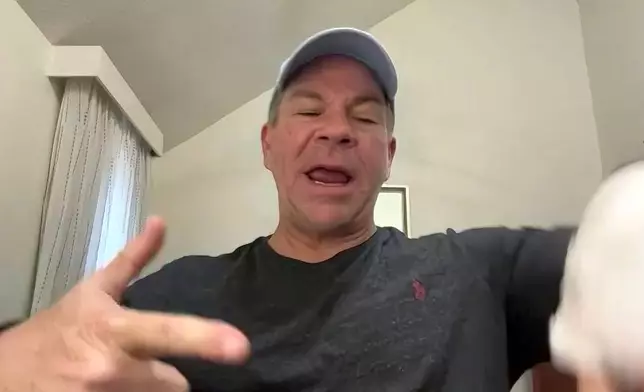 In this image taken from video, Michael Black, a Rhode Island man who helped stop a shooter at a high school hockey game on Monday, gestures during an interview with The Associated Press, Thursday, Feb. 19, 2026 in Spartanburg, S.C. (AP Photo)