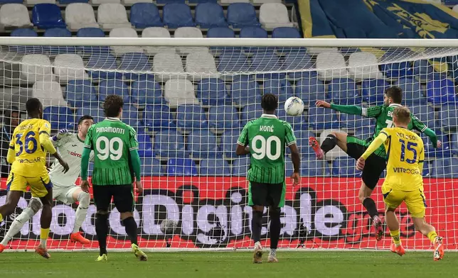 Sassuolo's Domenico Berardi, second form right, scores, during the Serie A soccer match between Sassuolo and Verona in Reggio Emilia, Italy, Friday Feb. 20, 2026. (Gianni Santandrea/LaPresse via AP)