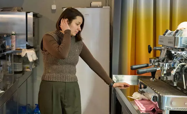 Co-founder of a cafe Yana Bilym, 33, reacts in her inactive cafe because of Russia's air attacks on the country's energy system Friday, Jan. 30, 2026 in Kyiv. (AP Photo/Efrem Lukatsky)
