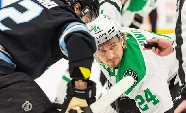 Dallas Stars center Roope Hintz (24) faces off against Utah Mammoth center Kevin Stenlund, left, during the second period of an NHL hockey game Saturday, Jan. 31, 2026, in Salt Lake City. (AP Photo/Melissa Majchrzak)