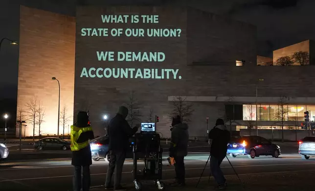 An image is projected onto the exterior wall of the National Gallery of Art near the U.S. Capitol in Washington, Monday, Feb. 23, 2026, ahead of President Donald Trump's State of the Union address. (AP Photo/Matt Rourke)