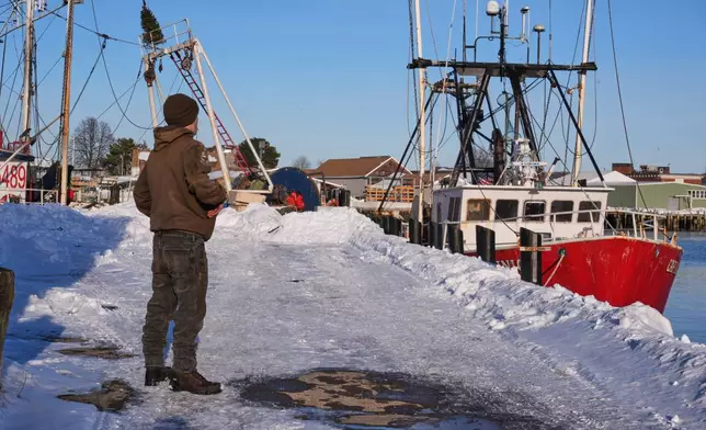 Gryphon Orfanos, who in the past worked on the fishing vessel "Lily Jean", stands on the pier of the homeport of the fishing boat that went missing with seven onboard, Monday, Feb. 2, 2026, in Gloucester, Mass. (AP Photo/Charles Krupa)
