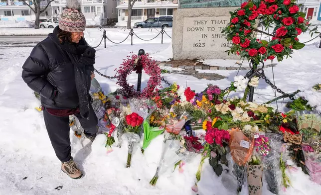 Christine Porper of Gloucester, Mass. pauses at the fisherman's memorial near the homeport of a fishing boat that went missing with seven onboard, Monday, Feb. 2, 2026, in Gloucester, Mass. (AP Photo/Charles Krupa)