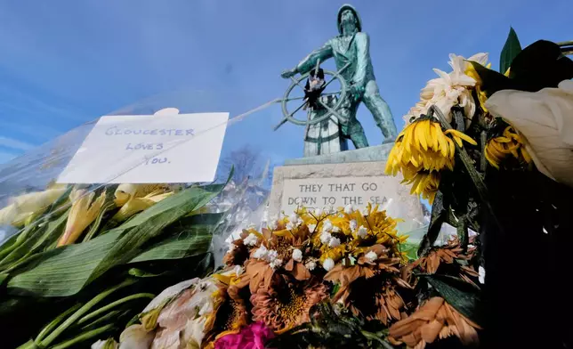 Flowers are left at fisherman's memorial near the homeport of a fishing boat that went missing with seven onboard, Monday, Feb. 2, 2026, in Gloucester, Mass. (AP Photo/Charles Krupa)
