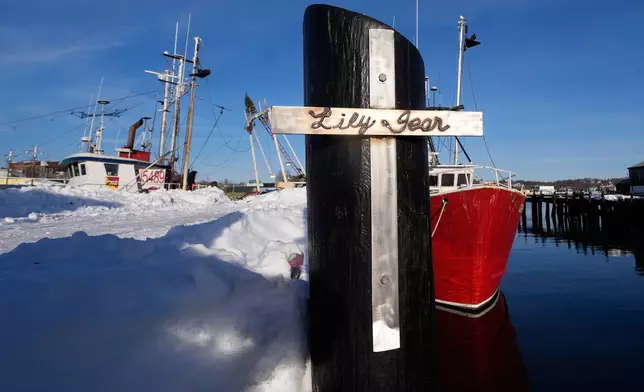 A crucifix, made by a friend of the captain of the fishing boat "Lily Jean", is displayed on the pier of the homeport of the fishing boat that went missing with seven onboard, Monday, Feb. 2, 2026, in Gloucester, Mass. (AP Photo/Charles Krupa)
