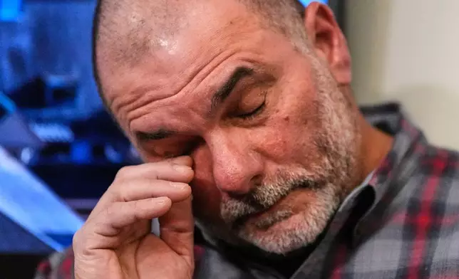 Al Cattone, friend of the late Capt. Gus Sanfilippo, reacts while listening to friends and officials remember the victims of the fishing boat that went missing, Monday, Feb. 2, 2026, in Gloucester, Mass. (AP Photo/Charles Krupa)