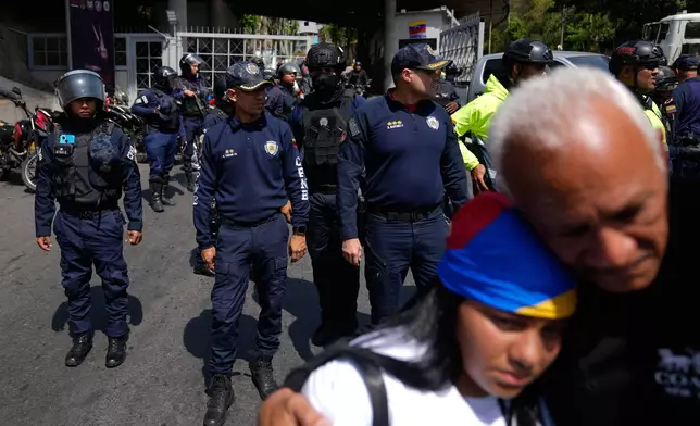 Police standby to keep people from advancing closer to the Helicoide detention center after the crowd attended a prayer for freedom of political prisoners, peace and reconciliation in Caracas, Venezuela, Saturday, Feb. 7, 2026. (AP Photo/Ariana Cubillos)