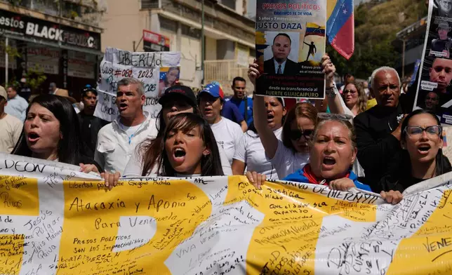 People protest near the Helicoide detention center after the crowd attended a prayer for freedom of political prisoners, peace and reconciliation in Caracas, Venezuela, Saturday, Feb. 7, 2026. (AP Photo/Ariana Cubillos)
