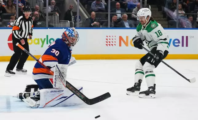 New York Islanders goaltender Ilya Sorokin (30) stops a shot by Dallas Stars' Sam Steel (18) during the first period of an NHL hockey game Thursday, March 26, 2026, in Elmont, N.Y. (AP Photo/Frank Franklin II)