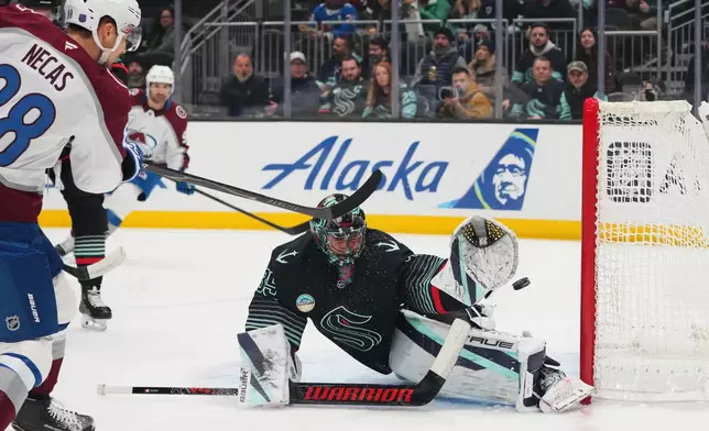 Colorado Avalanche center Martin Necas (88) scores against Seattle Kraken goaltender Joey Daccord (35) during the first period of an NHL hockey game Thursday, March 12, 2026, in Seattle. (AP Photo/Lindsey Wasson)