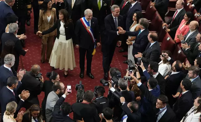 Chile's President Jose Antonio Kast, center, and his wife Maria Pia Adriasola greet guests on his inauguration day at Congress in Valparaiso, Chile, Wednesday, March 11, 2026. (AP Photo/Esteban Felix)