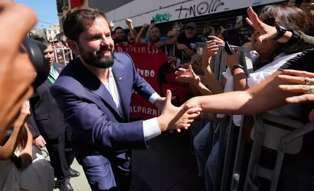 Outgoing President Gabriel Boric greets supporters as he leaves after President Jose Antonio Kast's swearing-in ceremony in Valparaiso, Chile, Wednesday, March 11, 2026. (AP Photo/Gustavo Garello)