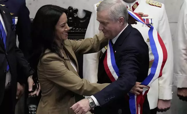Senate President Paulina Nunez, left, places the presidential sash on incoming President Jose Antonio Kast during his inauguration in Valparaiso, Chile, Wednesday, March 11, 2026. (AP Photo/Esteban Felix)
