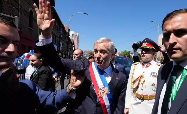 Chile's President Jose Antonio Kast waves to supporters as he leaves Congress after his swearing-in ceremony in Valparaiso, Chile, Wednesday, March 11, 2026. (AP Photo/Gustavo Garello)