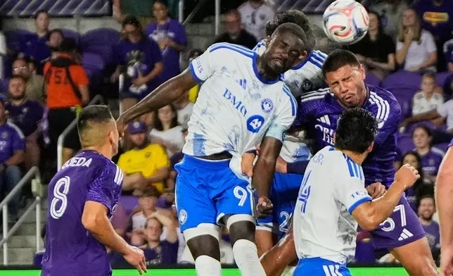 CF Montreal forward Prince Owusu (9) heads the ball to score a goal off a corner kick against Orlando City defender Iago during the first half of an MLS soccer match, Saturday, March 14, 2026, in Orlando, Fla. (AP Photo/John Raoux)