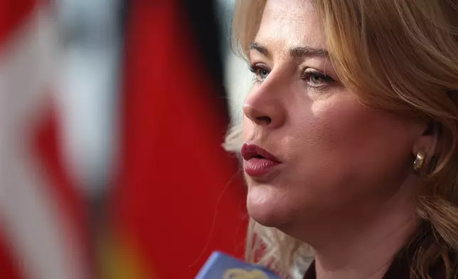 Latvia's Prime Minister Evika Silina speaks with the media as she arrives for the EU summit at the European Council building in Brussels, Thursday, March 19, 2026. (AP Photo/Omar Havana)