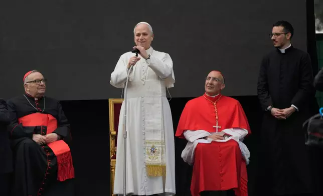 Cardinal Francesco Montenegro, left, and from right, Father Paolo Stacchiotti and Cardinal Baldo Reina listen to Pope Leo XIV during a visit to the parish complex of Santa Maria della Presentazione on the outskirts of Rome, Sunday, March 8, 2026. (AP Photo/Gregorio Borgia)