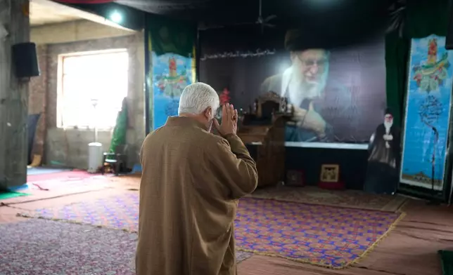 A Shiite Muslim man prays as he arrives to contribute to a relief drive for Iran in Budgam, Indian-controlled Kashmir, Monday, March 23, 2026. (AP Photo/Mukhtar Khan)