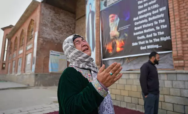 A Shiite Muslim woman is overcome with emotion as she arrives to contribute to an Iranian donation drive in Budgam, Indian-controlled Kashmir, Monday, March 23, 2026. (AP Photo/Mukhtar Khan)