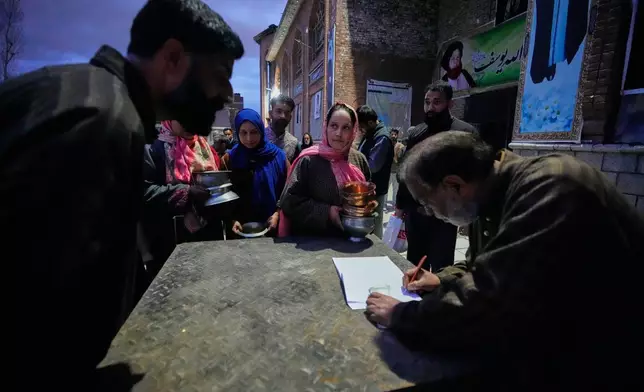 Shiite Muslim women wait to donate copper kitchenware during a relief drive for Iran in Budgam, Indian-controlled Kashmir, Monday, March 23, 2026. (AP Photo/Mukhtar Khan)