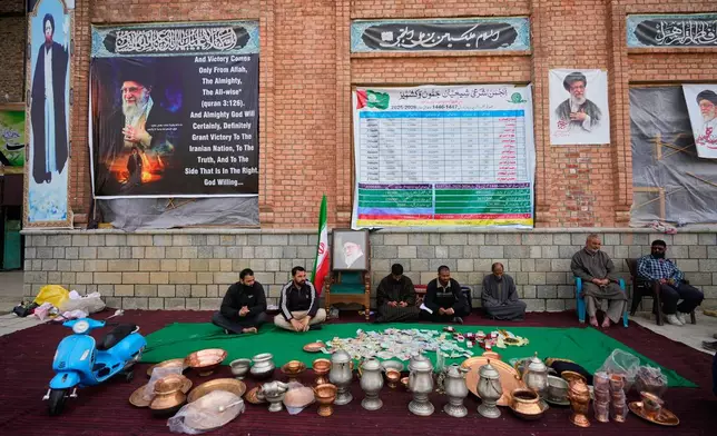 Volunteers wait at a collection point during a donation drive for Iran in Budgam, Indian-controlled Kashmir, Monday, March 23, 2026. (AP Photo/Mukhtar Khan)