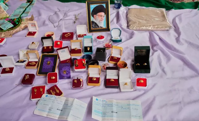 Personal jewelry and cheques are displayed among items collected during a relief drive for Iran in Budgam, Indian-controlled Kashmir, Monday, March 23, 2026. (AP Photo/Mukhtar Khan)