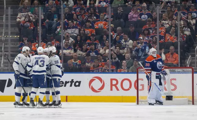 Tampa Bay Lightning players celebrate a goal against the Edmonton Oilers during the second period of an NHL hockey game in Edmonton on Saturday, March 21, 2026. (Jason Franson/The Canadian Press via AP)
