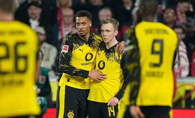 Dortmund's Maximilian Beier, right, is celebrated by Dortmund's Felix Nmecha after scoring the second goal during a German Bundesliga soccer match between 1.FC Koeln and Borussia Dortmund in Cologne, Germany, Saturday, March 7, 2026. (AP Photo/Martin Meissner)