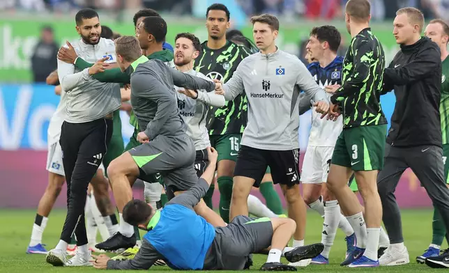 An altercation between Hamburger and Wolfsburg players following their German Bundesliga soccer match in Wolfsburg, Germany, Saturday, March 7, 2026. (Andreas Gora/dpa via AP)