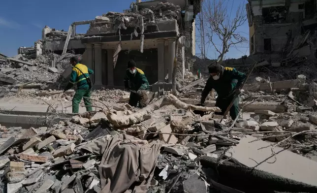 Workers remove the rubble of a police facility struck during the U.S.–Israeli military campaign in Tehran, Iran, Wednesday, March 4, 2026. (AP Photo/Vahid Salemi)