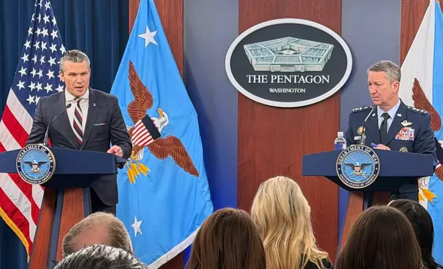 Defense Secretary Pete Hegseth and Chairman of the Joint Chiefs of Staff Gen. Dan Caine, speak during a press briefing at the Pentagon, Wednesday, March 4, 2026, in Washington. (AP Photo/Konstantin Toropin)