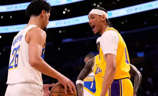 Los Angeles Lakers center Jaxson Hayes, right, jokes with Indiana Pacers guard Ben Sheppard after dunking during the first half of an NBA basketball game Friday, March 6, 2026, in Los Angeles. (AP Photo/Mark J. Terrill)