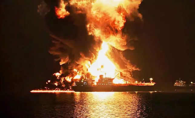 An oil tanker burns after being hit by an Iranian strike in the ship-to-ship transfer zone at Khor al-Zubair port near Basra, Iraq, late Wednesday, March 11, 2026. (AP Photo)