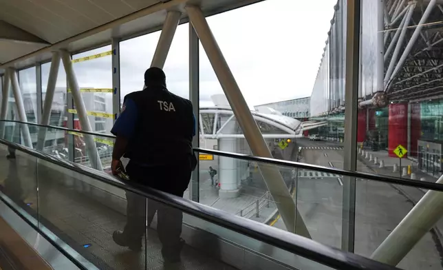 A Transportation Security Administration agent leaves the terminal following their shift at Baltimore/Washington International Thurgood Marshall Airport in Baltimore, Monday, March 23, 2026. (AP Photo/Stephanie Scarbrough)
