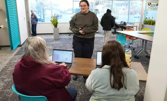Taylor Desert, a TSA agent, checks in to pick up groceries at Gleaners Food Bank in Indianapolis, Monday, March 23, 2026. (AP Photo/Michael Conroy)