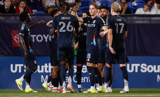 San Diego FC's Onni Valakari (8) is congratulated by teammates after scoring on a penalty kick during an MLS soccer match against FC Dallas, Saturday, March 14, 2026, in Frisco, Texas. (AP Photo/Brandon Wade)