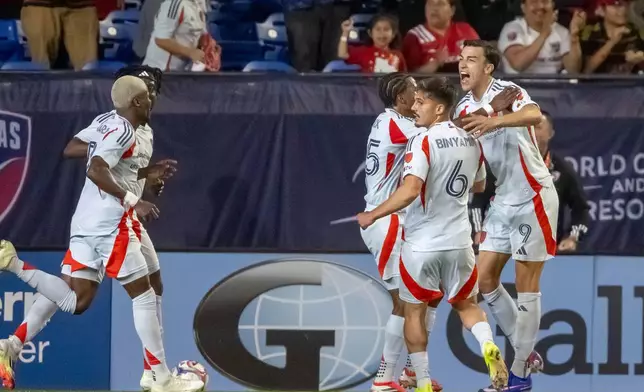 FC Dallas' Petar Musa (9) is congratulated by teammates after scoring his third goal, tying the game, during an MLS soccer match, Saturday, March 14, 2026, in Frisco, Texas. (AP Photo/Brandon Wade)