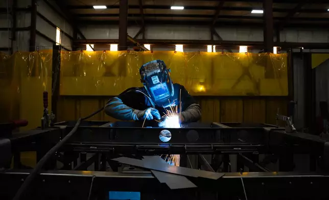A welder is seen inside the Allen Engineering Corporation plant Monday, March 16, 2026, in Paragould, Ark. (AP Photo/Kevin Wurm)