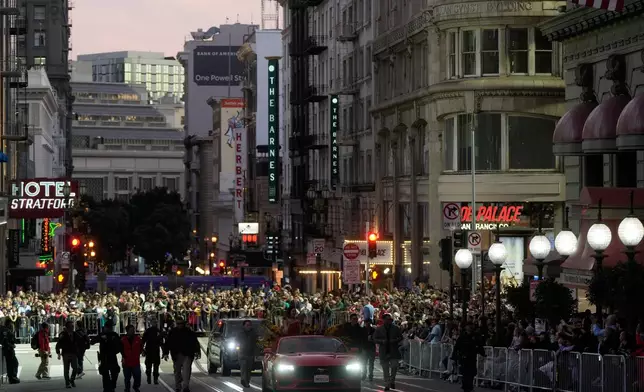 Olympic gold medalist and Grand Marhsal Eileen Gu, bottom middle, waves during the Chinese New Year Parade in San Francisco, Saturday, March 7, 2026. (AP Photo/Jeff Chiu)