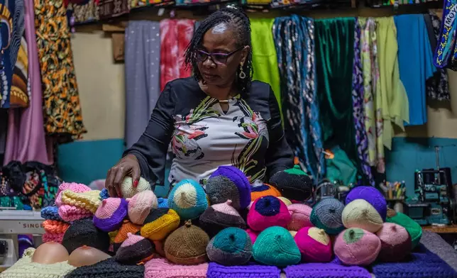 Mary Mwangi, 52, a breast cancer survivor, displays knitted breast prostheses at her shop in Thika, Kiambu County, Kenya, Friday, Jan. 30, 2026. (AP Photo/Samson Otieno)