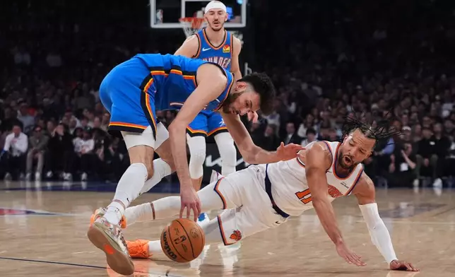 Oklahoma City Thunder's Chet Holmgren (7) fights for control of the ball with New York Knicks' Jalen Brunson (11) during the first half of an NBA basketball game Wednesday, March 4, 2026, in New York. (AP Photo/Frank Franklin II)