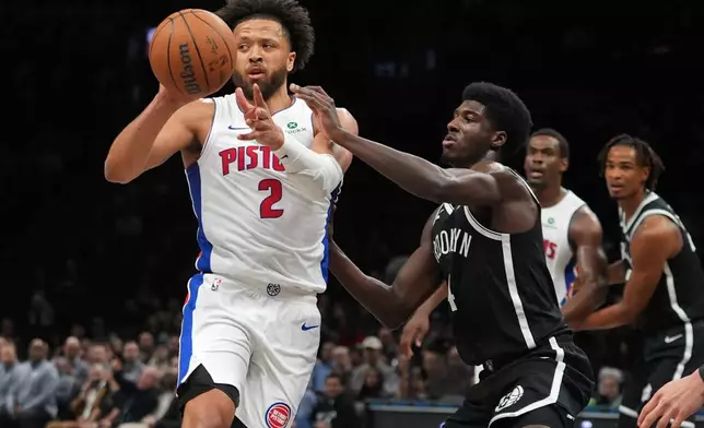Detroit Pistons' Cade Cunningham (2) passes away from Brooklyn Nets' Drake Powell (4) during the first half of an NBA basketball game Tuesday, March 10, 2026, in New York. (AP Photo/Frank Franklin II)