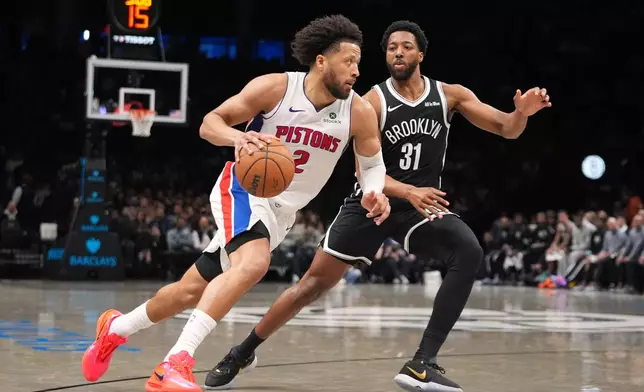 Detroit Pistons' Cade Cunningham (2) drives past Brooklyn Nets' Chaney Johnson (31) during the first half of an NBA basketball game Tuesday, March 10, 2026, in New York. (AP Photo/Frank Franklin II)