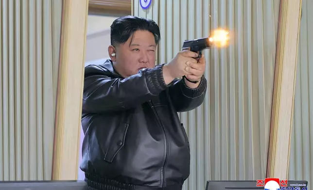 In this photo provided by the North Korean government, its leader Kim Jong Un tries out a new pistol at a factory producing pistols and other light arms at an undisclosed place in North Korea Wednesday, March 11, 2026. Independent journalists were not given access to cover the event depicted in this image distributed by the North Korean government. The content of this image is as provided and cannot be independently verified. Korean language watermark on image as provided by source reads: "KCNA" which is the abbreviation for Korean Central News Agency. (Korean Central News Agency/Korea News Service via AP)