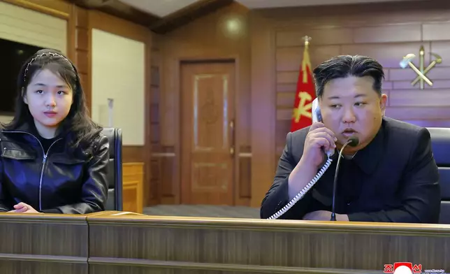 This photo provided by the North Korean government shows its leader Kim Jong Un, right, and his daughter, left, watch what it says the cruise missiles launches from the naval destroyer, the Choe Hyon, via video Tuesday, March 10, 2026, in North Korea. Independent journalists were not given access to cover the event depicted in this image distributed by the North Korean government. The content of this image is as provided and cannot be independently verified. Korean language watermark on image as provided by source reads: "KCNA" which is the abbreviation for Korean Central News Agency. (Korean Central News Agency/Korea News Service via AP)